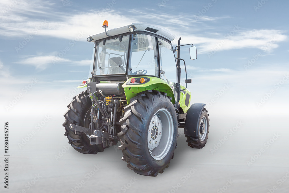 Obraz premium Modern wheeled tractor isolated on bright background with sky
