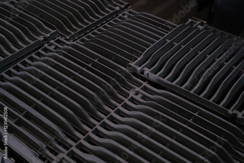 Close up of stacked dark gray metal grating panels Industrial texture and pattern