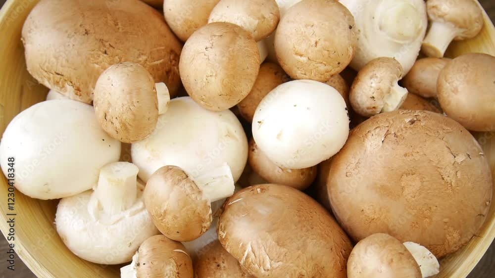 Champignon mushrooms in a wooden bowl. Champignon mushrooms in a wooden bowl.