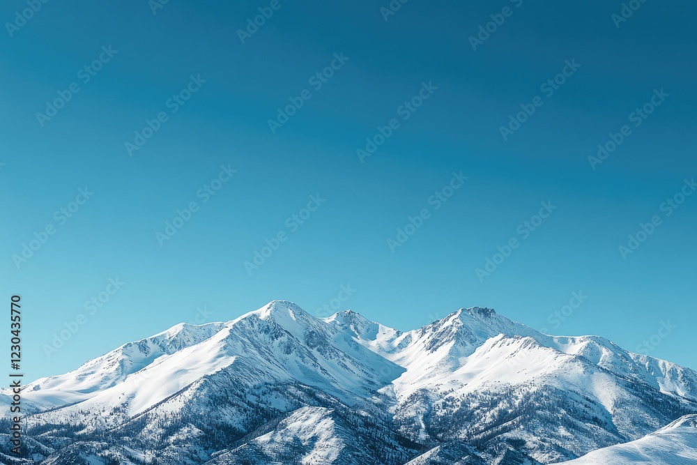 A mountain range with snow-covered peaks, under a clear blue sky A mountain range with snow-covered peaks, under a clear blue sky