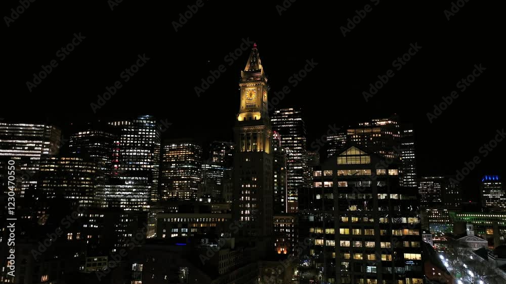 Custom House Tower glowing in Boston’s Financial District skyline. Surrounding skyscrapers lit at night with vibrant office windows. Stunning urban aerial with historic and modern architecture. Custom House Tower glowing in Boston’s Financial District skyline. Surrounding skyscrapers lit at night with vibrant office windows. Stunning urban aerial with historic and modern architecture.