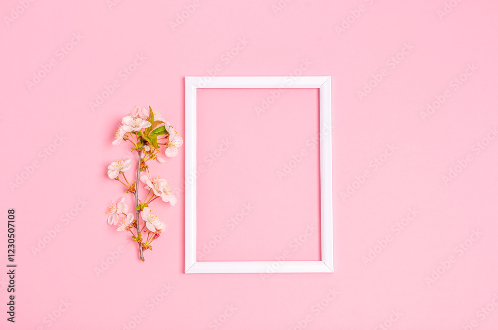 Apricot branch and white frame on a pink background with space for text. Apricot branch and white frame on a pink background with space for text.