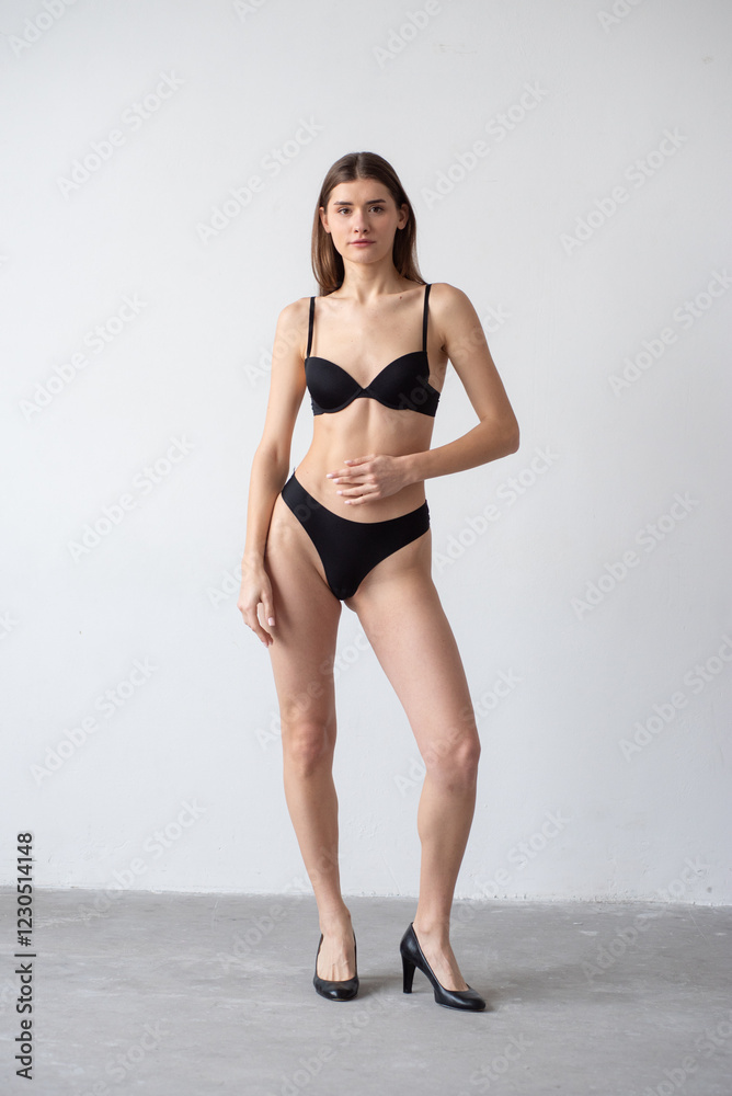 High-quality model polaroid featuring a tall, fit woman in a minimalistic studio environment. Showcasing a neutral expression, toned physique, and poised posture for fashion industry standards. High-quality model polaroid featuring a tall, fit woman in a minimalistic studio environment. Showcasing a neutral expression, toned physique, and poised posture for fashion industry standards.