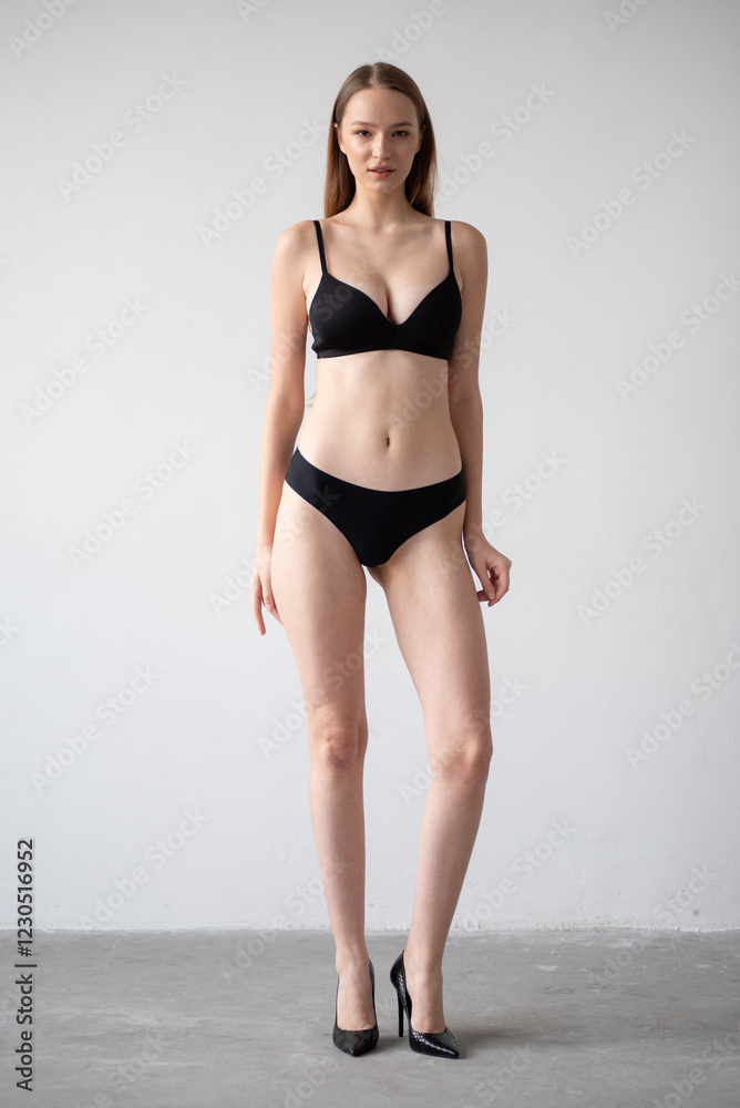 Casting snapshot of a fresh-faced model in simple black underwear, highlighting her natural features, body proportions, and confident stance. Ideal for agency scouting and professional portfolio updat Casting snapshot of a fresh-faced model in simple black underwear, highlighting her natural features, body proportions, and confident stance. Ideal for agency scouting and professional portfolio updat