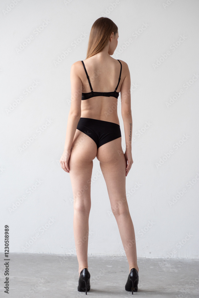 Casting snapshot of a fresh-faced model in simple black underwear, highlighting her natural features, body proportions, and confident stance. Ideal for agency scouting and professional portfolio updat Casting snapshot of a fresh-faced model in simple black underwear, highlighting her natural features, body proportions, and confident stance. Ideal for agency scouting and professional portfolio updat