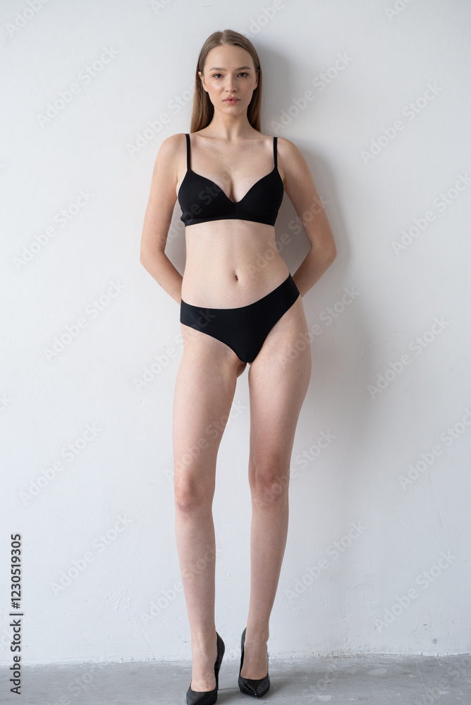 Casting snapshot of a fresh-faced model in simple black underwear, highlighting her natural features, body proportions, and confident stance. Ideal for agency scouting and professional portfolio updat Casting snapshot of a fresh-faced model in simple black underwear, highlighting her natural features, body proportions, and confident stance. Ideal for agency scouting and professional portfolio updat
