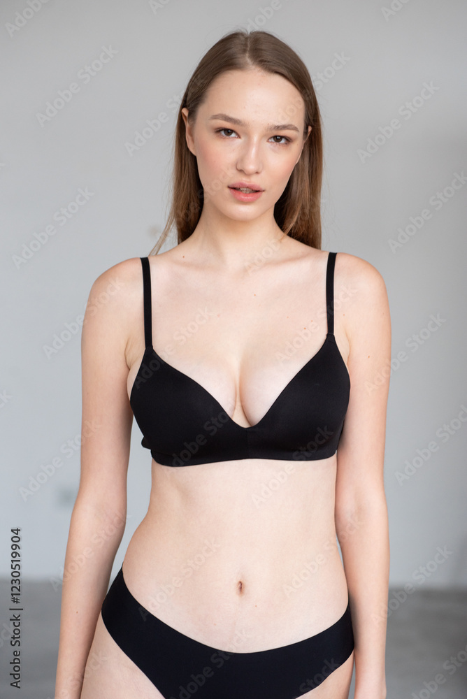 Professional modeling digitals of a young female model in black lingerie, standing confidently in a clean studio setting. Capturing natural beauty, symmetry, and elegance for agency submission Professional modeling digitals of a young female model in black lingerie, standing confidently in a clean studio setting. Capturing natural beauty, symmetry, and elegance for agency submission
