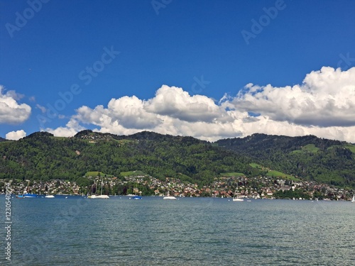 A lake in the Swiss Alps. The Blue Lake in Switzerland. Snow-capped mountains near the lake. Spring.
