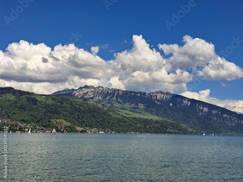 A lake in the Swiss Alps. The Blue Lake in Switzerland. Snow-capped mountains near the lake. Spring.