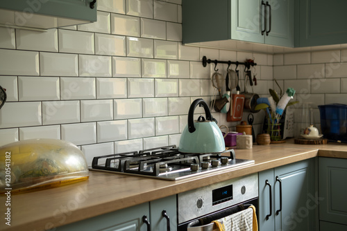 Foto A modern kitchen with light green cabinets, white subway tile backsplash