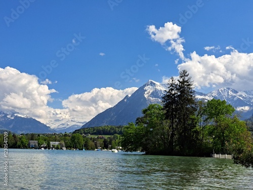 A lake in the Swiss Alps. The Blue Lake in Switzerland. Snow-capped mountains near the lake. Spring.