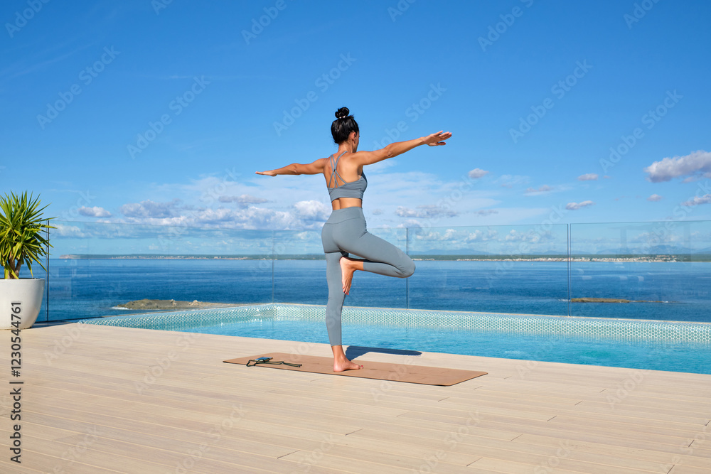 Woman Practicing Yoga by the Ocean on a Sunny Day on a terrace Woman Practicing Yoga by the Ocean on a Sunny Day on a terrace