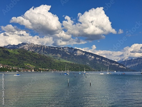A lake in the Swiss Alps. The Blue Lake in Switzerland. Snow-capped mountains near the lake. Spring.