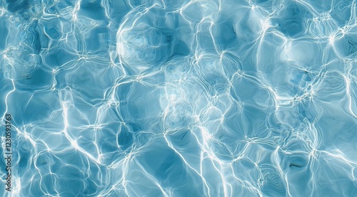 Beautiful clear blue water rippling in a swimming pool under bright sunlight
