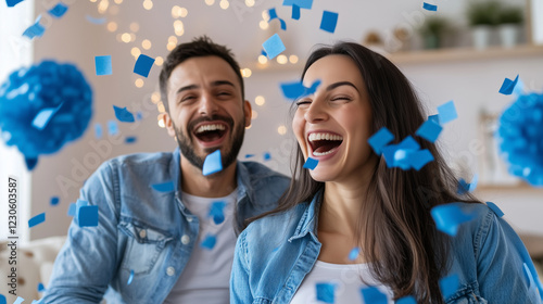 A joyous moment at a gender reveal party as a happy pregnant woman and her partner react with excitement upon learning itâs a boy. Blue confetti showers around them, with a confett photo