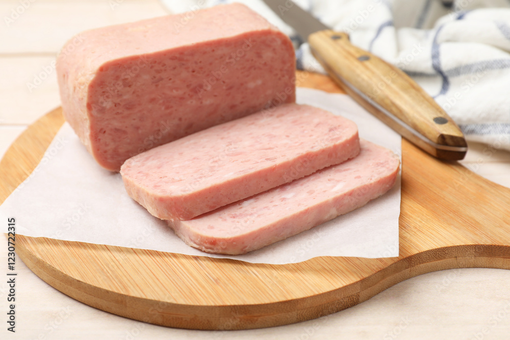 Tasty canned meat and knife on light table, closeup Tasty canned meat and knife on light table, closeup