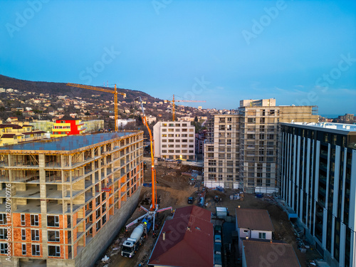 Bild auf Leinwand Aerial view of a construction site with a high-rise building under development