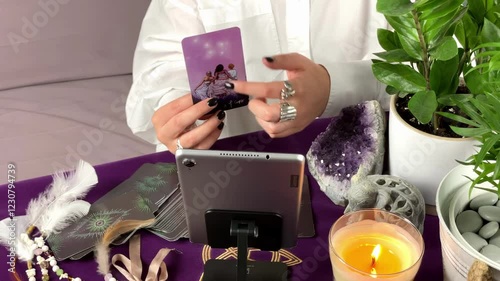 Online tarot consultation - two female hands showing and reading tarot cards through video call