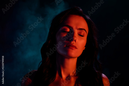 Photo of chic pure lady look with eye closed under red color neon light over dark background