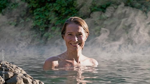 Loop Of Middle Aged Woman Smiling In Natural Hot Spring, Peaceful Spa Retreat Video 4K