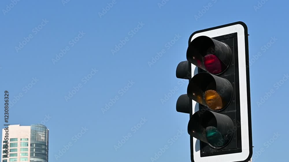 traffic lights on pole and blue sky in background