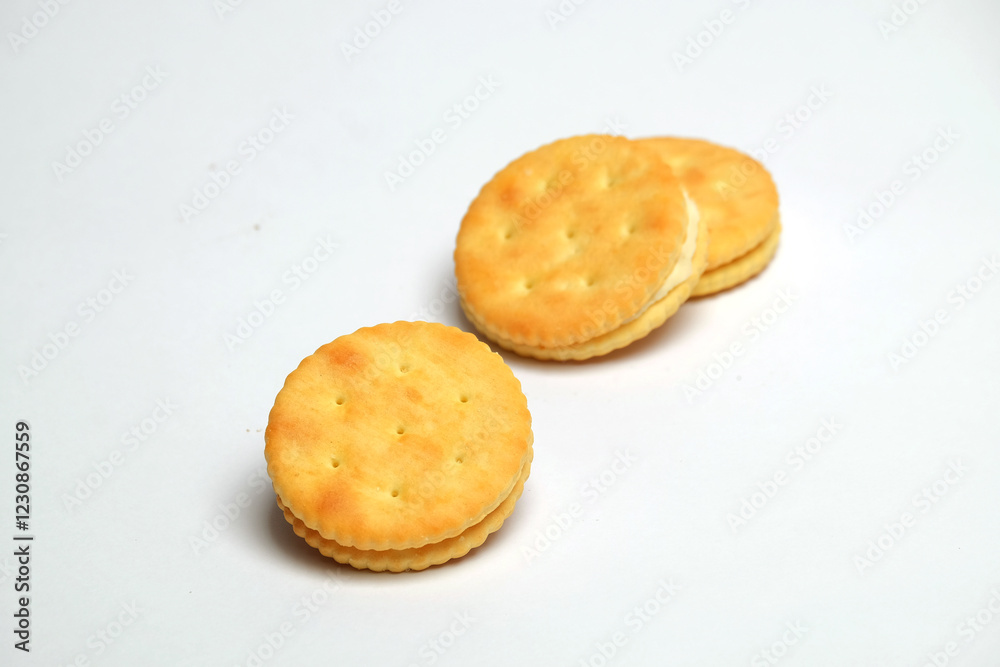 Cracker biscuits with butter and cream seasoning isolated on white background. Sweet and crunchy taste.Snack food industry concept.Copy space for text.For graphic design or banner background Cracker biscuits with butter and cream seasoning isolated on white background. Sweet and crunchy taste.Snack food industry concept.Copy space for text.For graphic design or banner background