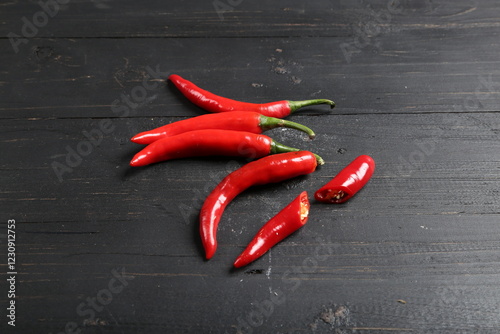 Fototapeta Naklejka Na Ścianę i Meble -  Fresh Red Chili Peppers on Black Wooden Background