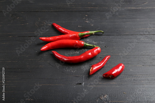 Fototapeta Naklejka Na Ścianę i Meble -  Fresh Red Chili Peppers on Black Wooden Background