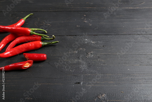 Fototapeta Naklejka Na Ścianę i Meble -  Fresh Red Chili Peppers on Black Wooden Background