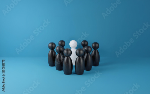 A single white figure stands out against a backdrop of black figures arranged in a circle. photo