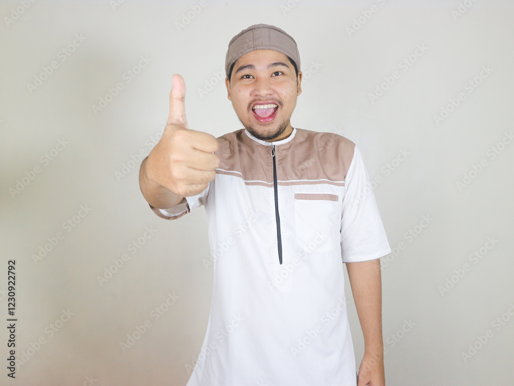 happy asian muslim man giving thumbs up. concept of Islamic religious people in the context of the month of Ramadan and Eid Mubarak happy asian muslim man giving thumbs up. concept of Islamic religious people in the context of the month of Ramadan and Eid Mubarak
