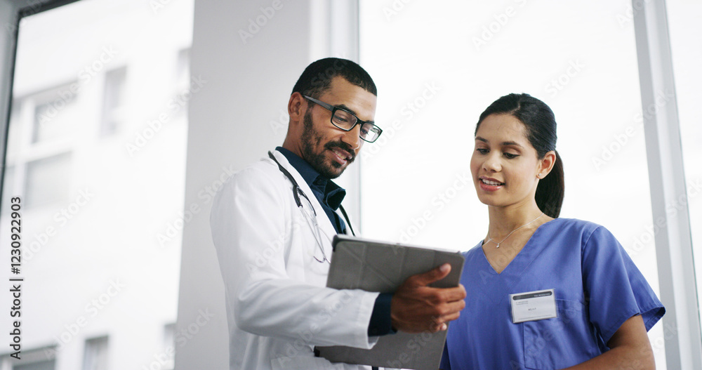 Fototapeta premium Healthcare, doctors and tablet in hospital for discussion, patient update or medical research. Below, man and nurse in clinic lobby for information report, good news or surgery feedback on technology