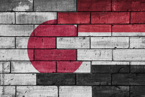 colourful painted big flag of japan and flag of yemen on a massive old brick wall background. concept photo