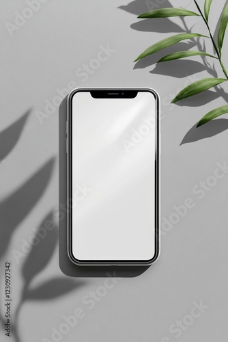 Wallpaper Mural Smartphone mockup with blank screen and tropical leaves casting shadows on grey background. Torontodigital.ca
