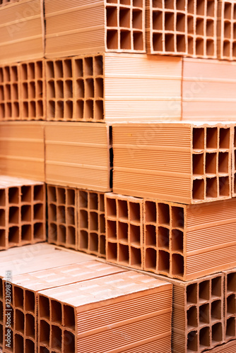 A stack of clay hollow blocks, each placed above the other. Construction environment.