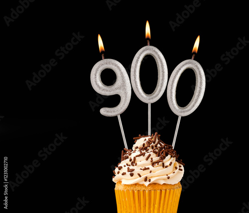 Candles forming the number 900 - Black background. photo