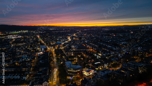 Cardiff city center glowing at sunset, aerial view of urban landscape