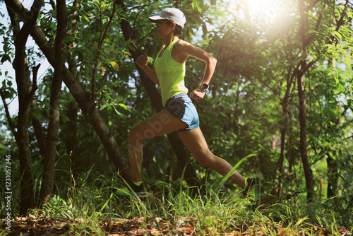 Photography Woman trail runner running at tropical forest mountain peak