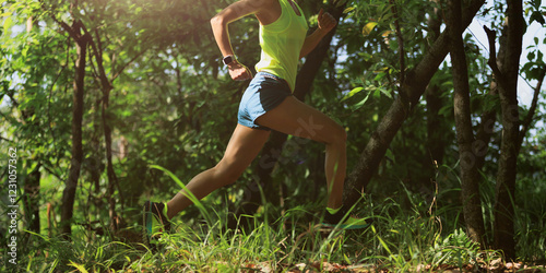 Photography Woman trail runner running at tropical forest mountain peak