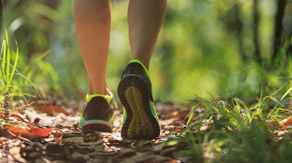 Woman runner running on forest trail Woman runner running on forest trail