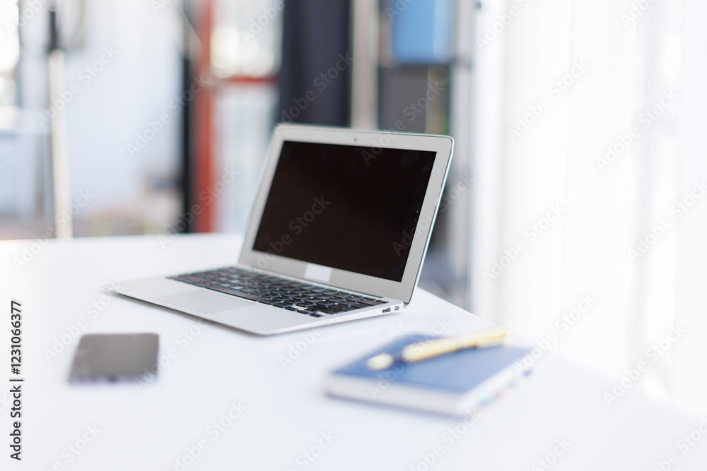 Screen laptop computer mockup a large open plan office space after working hours and accessories on a white desk in a modern office. Office workspace
Screen laptop computer mockup a large open plan office space after working hours and accessories on a white desk in a modern office. Office workspace