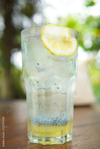 Glass of fresh lemonade squash with basil seed drink close up