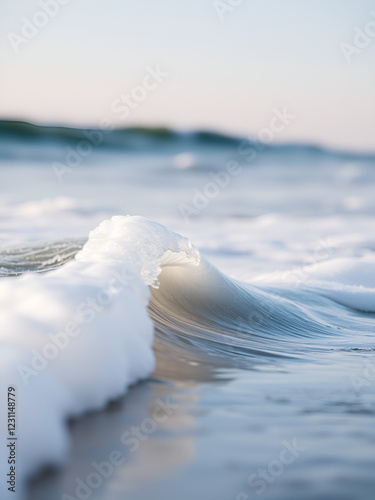 A close-up shot of a wave breaking on the beach, great for travel or nature-themed projects photo