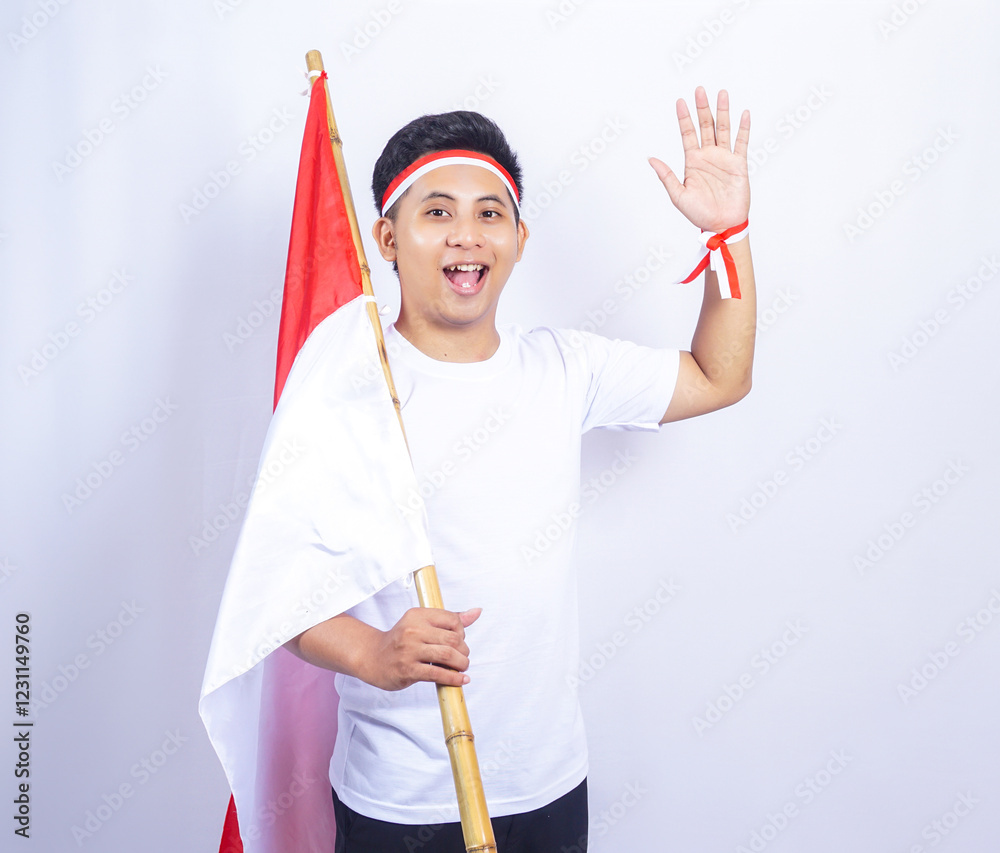 Indonesian Young Man Gesturing Hello to Greets People with Hand while Holding Country Flag Indonesian Young Man Gesturing Hello to Greets People with Hand while Holding Country Flag
