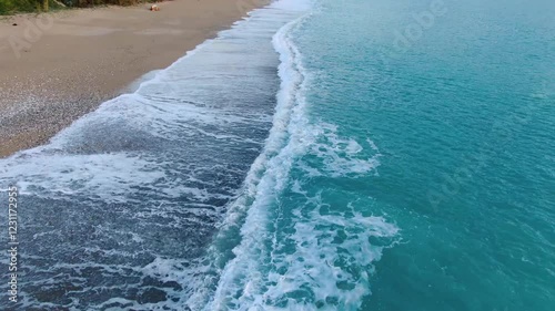 Ocean waves meeting sandy beach shoreline. Aerial view of coastal landscape. corfu island greece