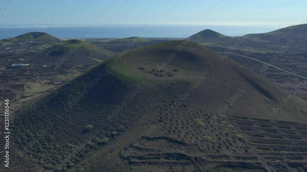 Aerial drone view of mountain sea and volcanoes in Lanzarote, Canary Islands, Spain