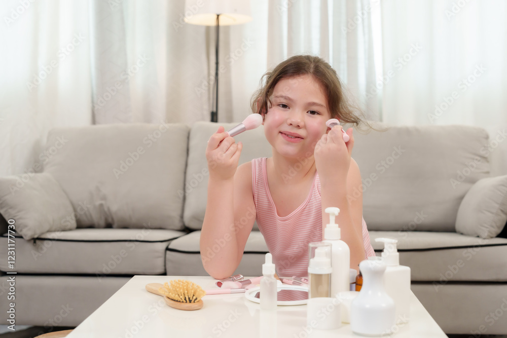 Cute Caucasian girl who loves beauty learning makeup by holding a brush in one hand and a pink curler in another. Sitting at a white table, smiling while enjoying playful beauty moments at home. Cute Caucasian girl who loves beauty learning makeup by holding a brush in one hand and a pink curler in another. Sitting at a white table, smiling while enjoying playful beauty moments at home.