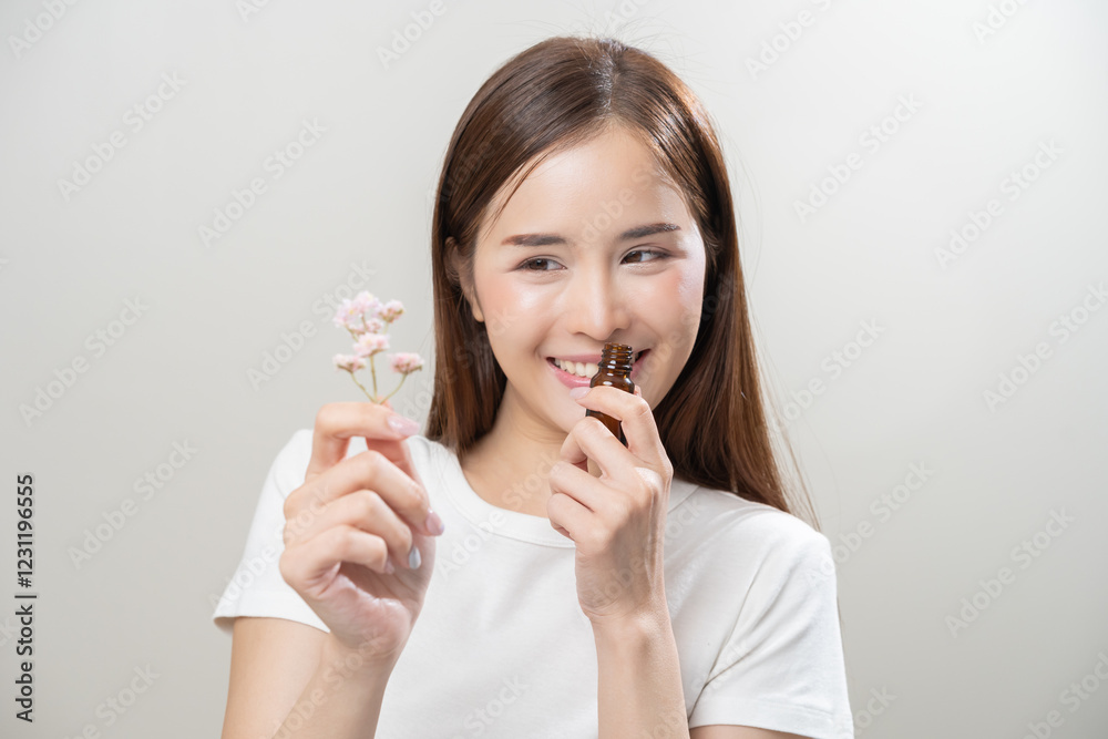 Aromatherapy, pretty asian young woman face expression enjoying smell fragrance of herbal from medicine natural organic essential perfume oil.Therapy treatment, beauty skin care isolated on background Aromatherapy, pretty asian young woman face expression enjoying smell fragrance of herbal from medicine natural organic essential perfume oil.Therapy treatment, beauty skin care isolated on background