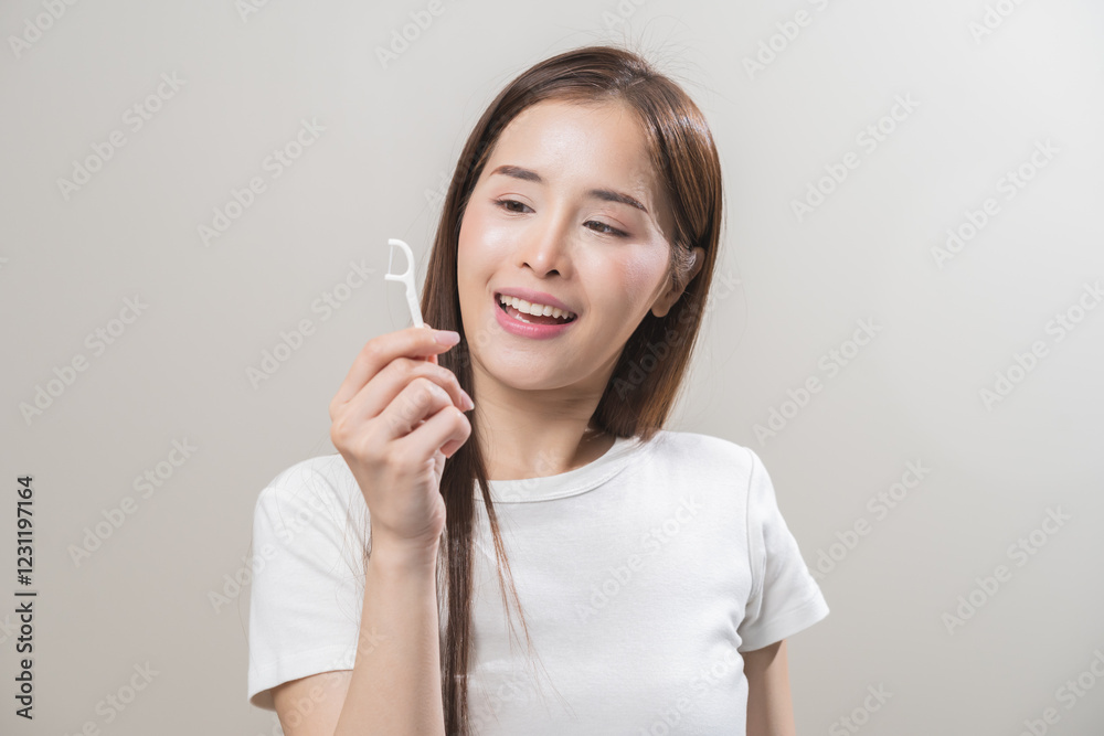 Flossing teeth, dental care hygiene, asian young woman flossing teeth with dental floss pick, smile happy with perfect white teeth, using tooth floss cleaning, healthy teeth isolated on background. Flossing teeth, dental care hygiene, asian young woman flossing teeth with dental floss pick, smile happy with perfect white teeth, using tooth floss cleaning, healthy teeth isolated on background.