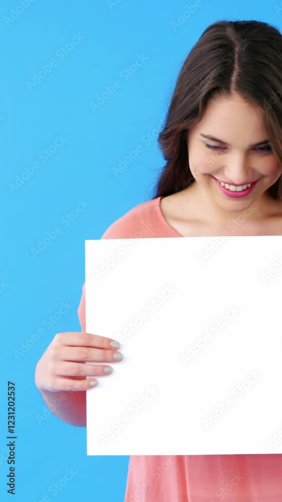 Beautiful woman holding blank placard on blue background Beautiful woman holding blank placard on blue background